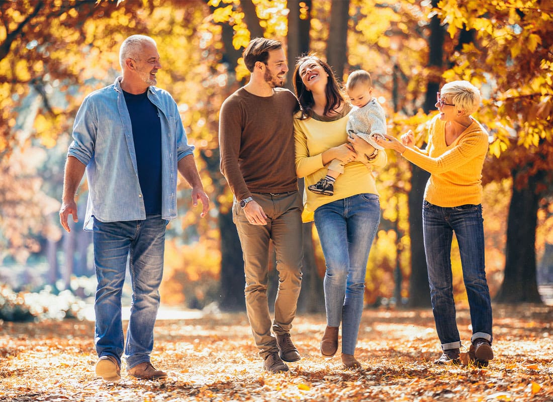 Personal Insurance - Multi Generational Family Taking a Walk at the Park Together During Autumn